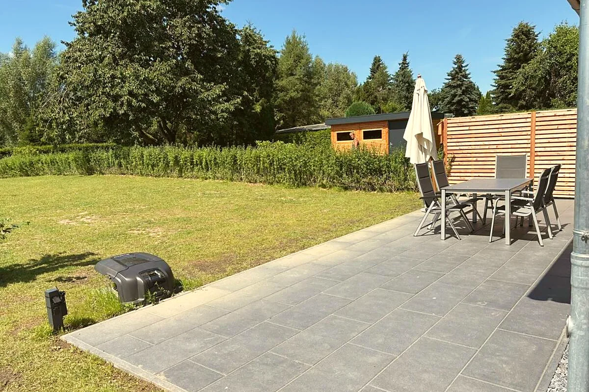 Sonnige Terrasse mit Sitzgruppe und Gartenblick