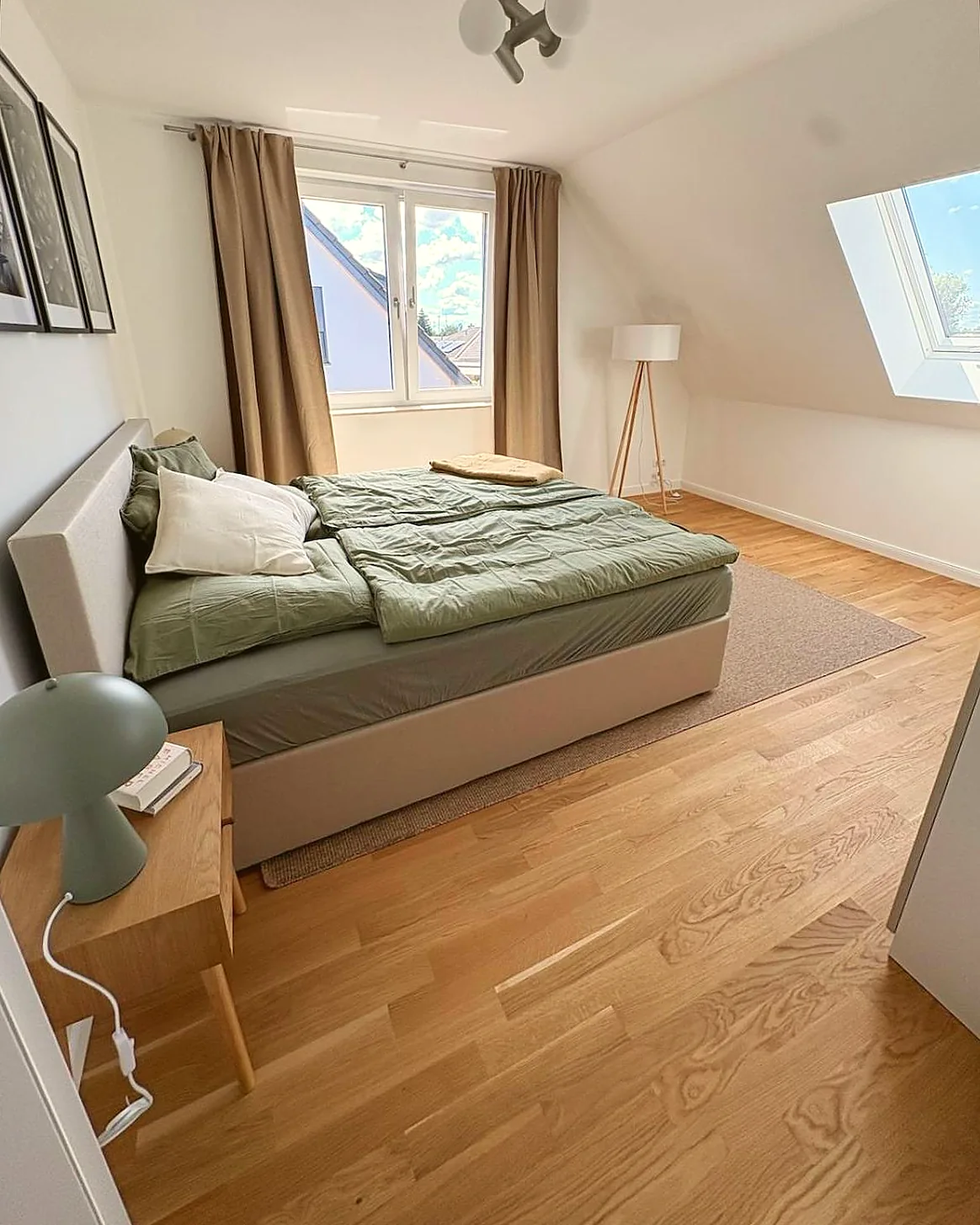Helles Schlafzimmer mit Doppelbett und Dachfenster